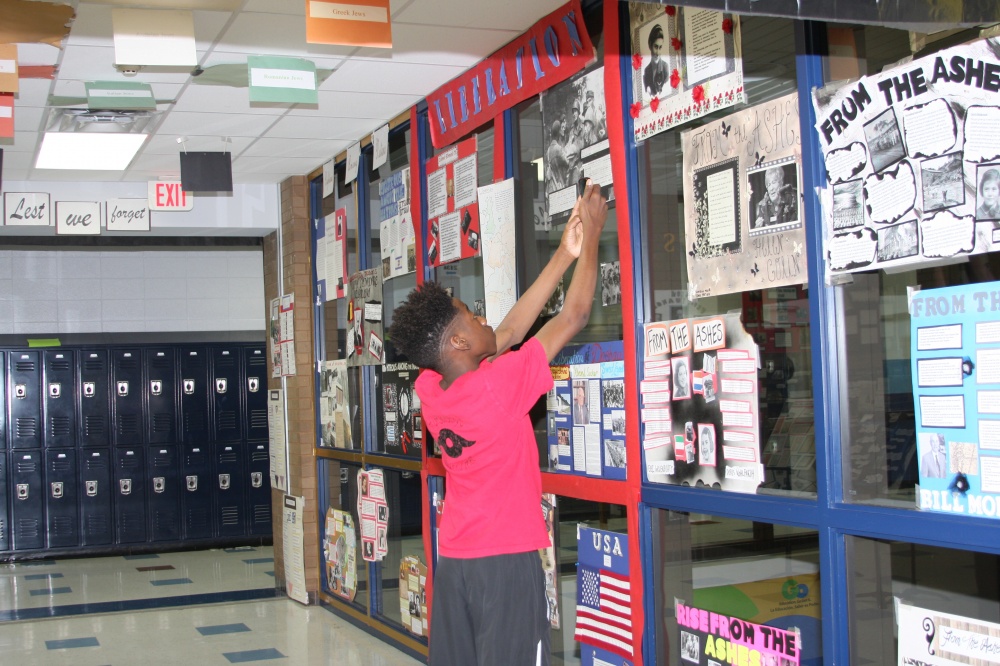 A student in Mike Madden’s class in Sugar Land, Texas, prepares the Hall of Remembrance to prepare for a community-wide event. 