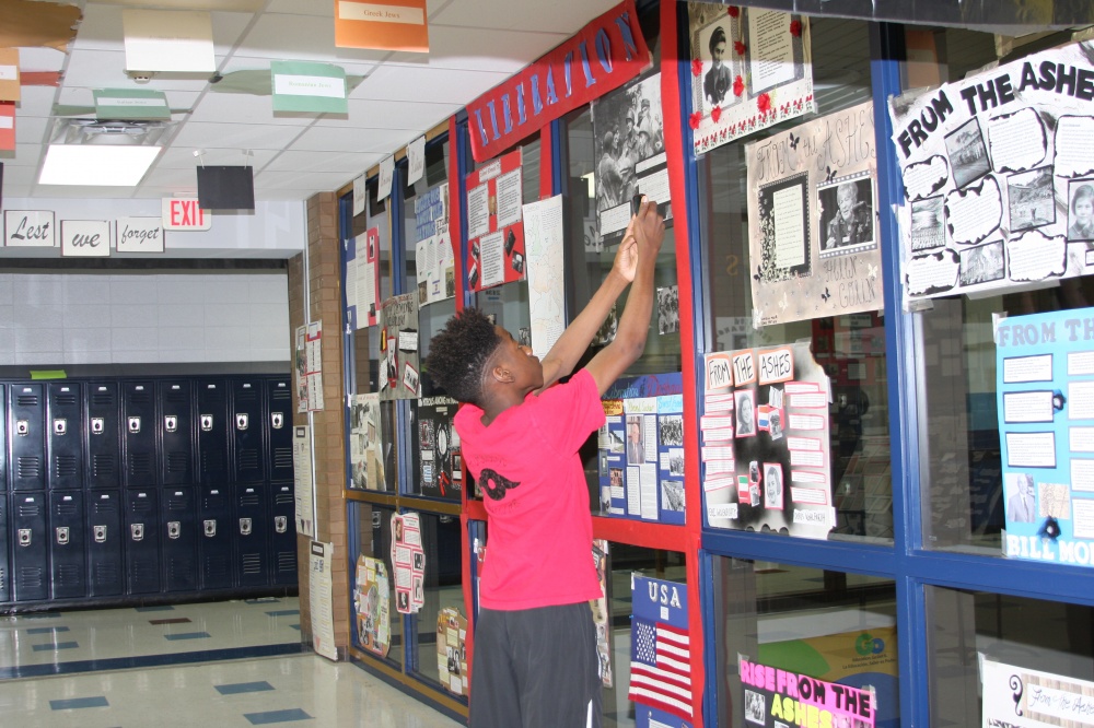 A student in Mike Madden’s class in Sugar Land, Texas, prepares the Hall of Remembrance to prepare for a community-wide event.