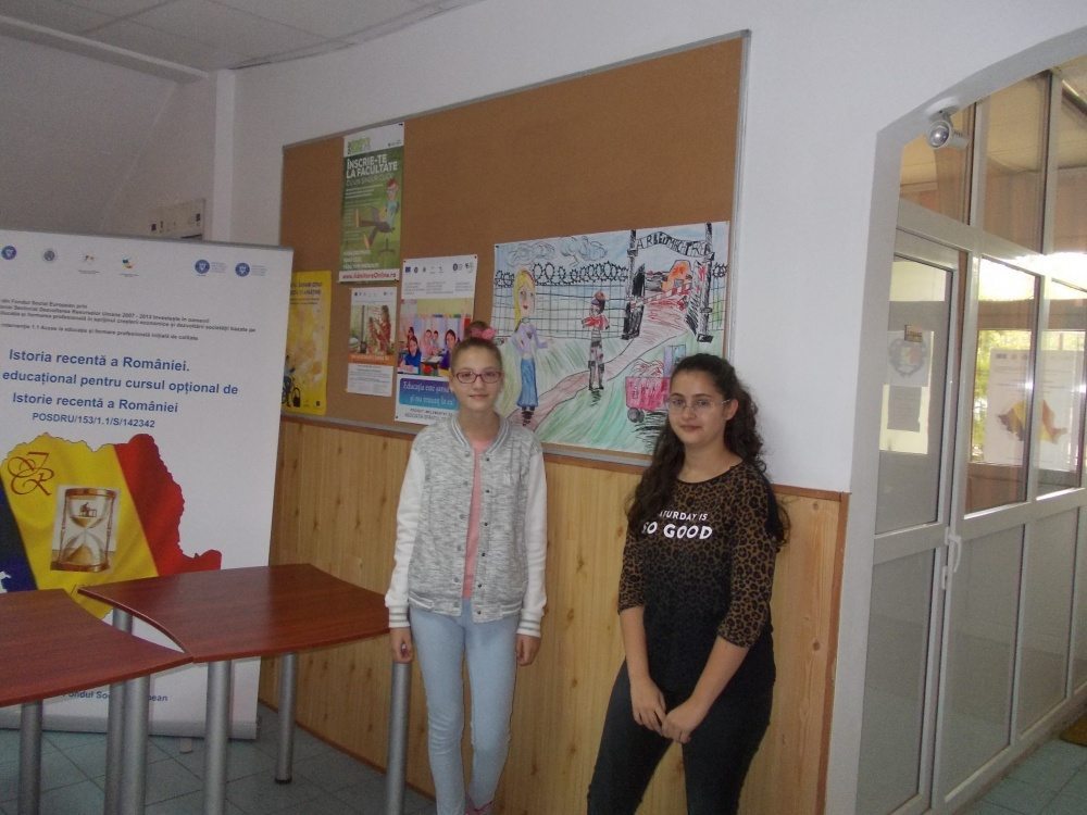 Eight grade students, participants in a Holocaust program at schools throughout Ilfov County, pose with their posters commemorating Holocaust victims as part of the Memory of the Holocaust national competition. 